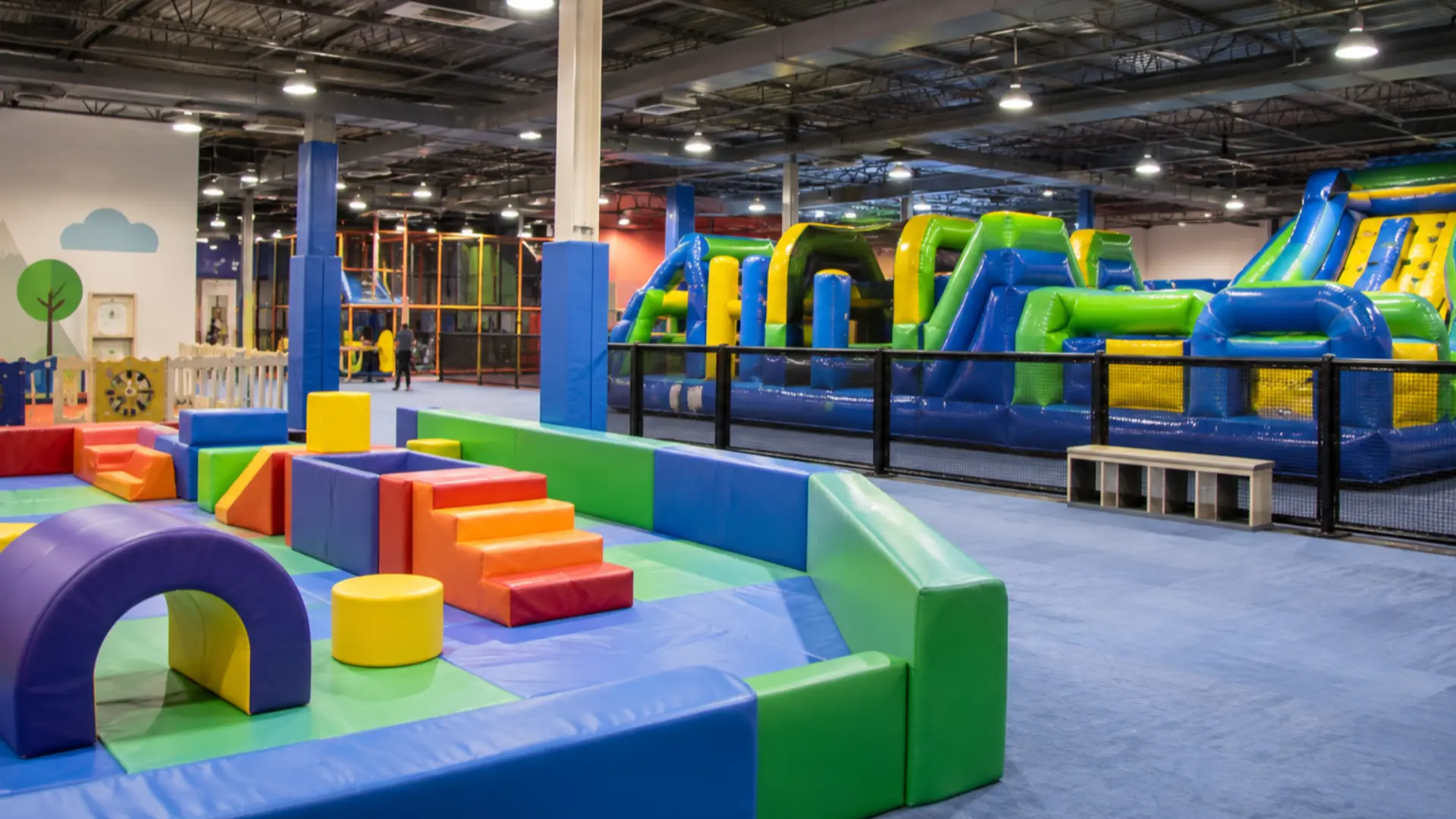 indoor family entertainment center with separate toddler and school-age inflatable play zones
